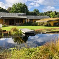 Large strawbale house set amongst mature planting.
Magnificent harbour views. Biopool. Food gardens