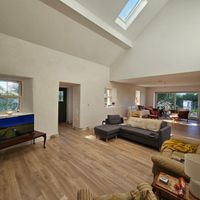Restored Irish cottage with a cosy fireplace, surrounded by fields, forests and lakes nearby.